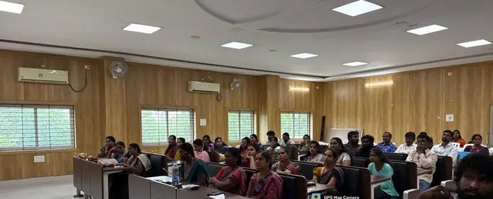 Participants seated in a wood-panelled hall