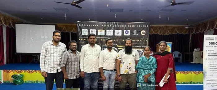 Resource persons and organisers on stage in front of the programme banner
