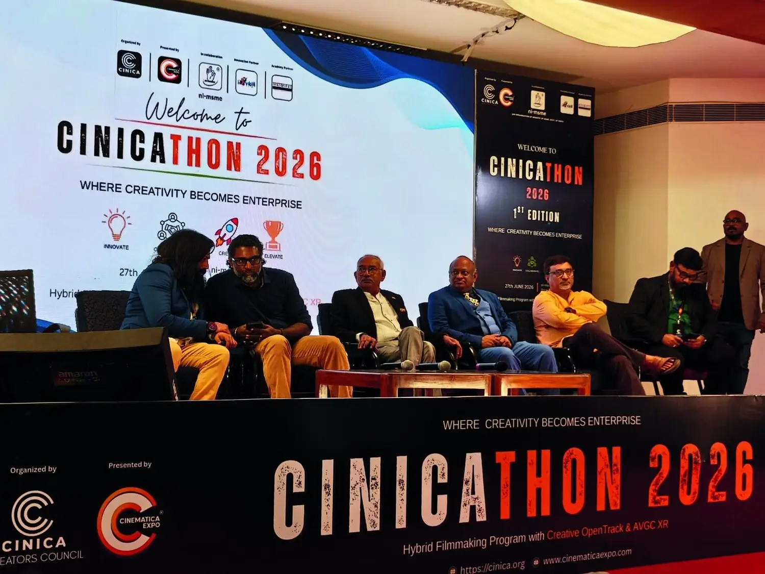 The CINICATHON 2026 stage at NI-MSME Hyderabad with speakers seated on the dais