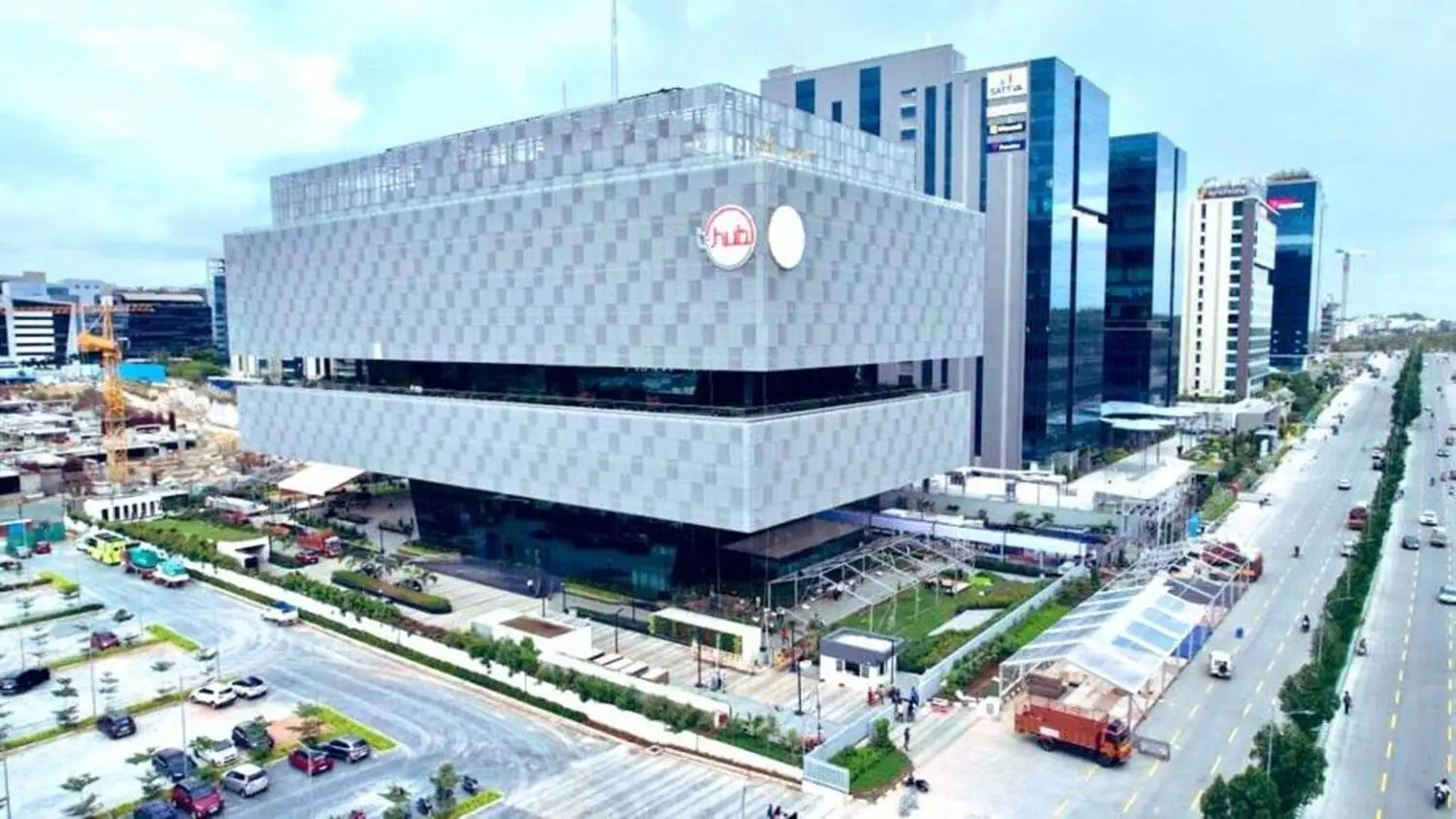 Aerial view of the T-Hub building in Hyderabad, with its stacked grey facade and red T-Hub roundel